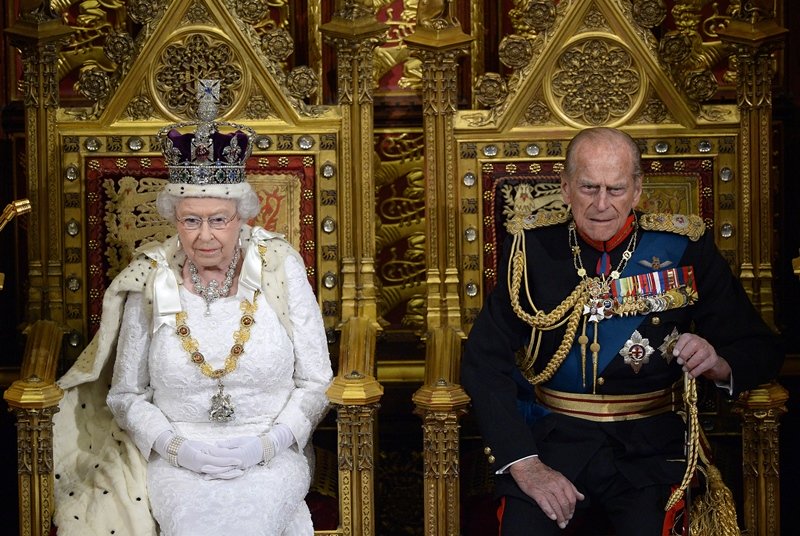 a file photo britain 039 s queen elizabeth ii l seated on the throne in the house of lords next to prince philip duke of edinburgh r photo afp