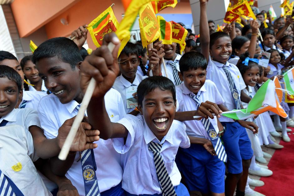 sri lankan school children cheer as they welcome sri lankan president mahinda rajapakse to the rebuilt jaffna railway station in october 2014 photo afp