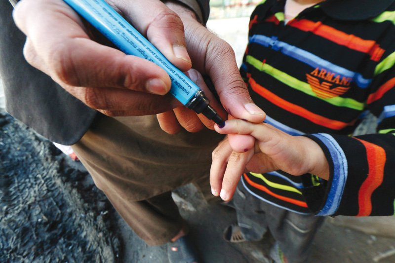 health worker marks a child s finger after administering polio drops at pajagi road photo muhammad iqbal express