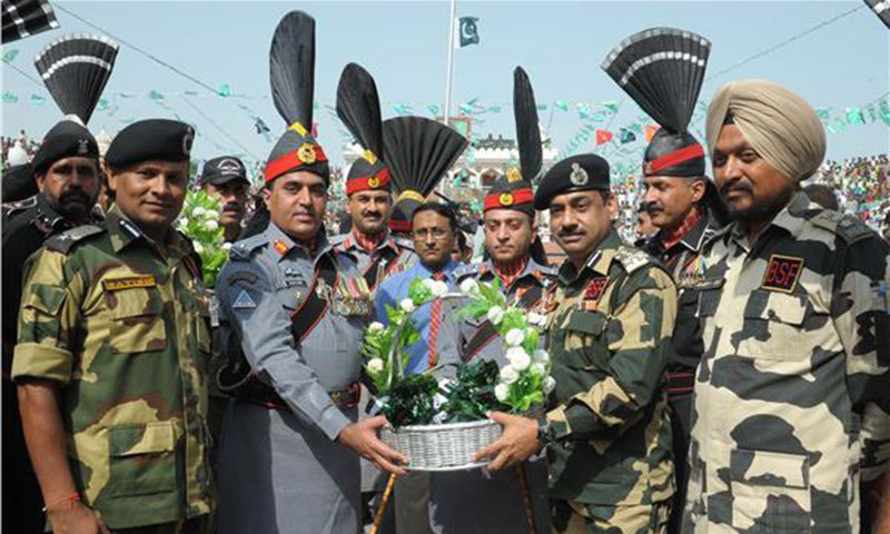 a file photo of pakistani and indian border troops exchanging sweets photo afp