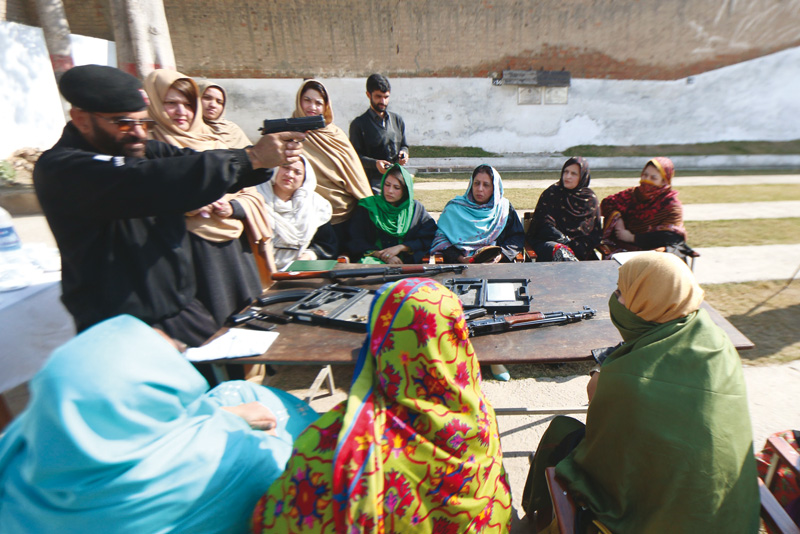 police officials train teachers of frontier college for women how to use guns at police lines photo muhammad iqbal express