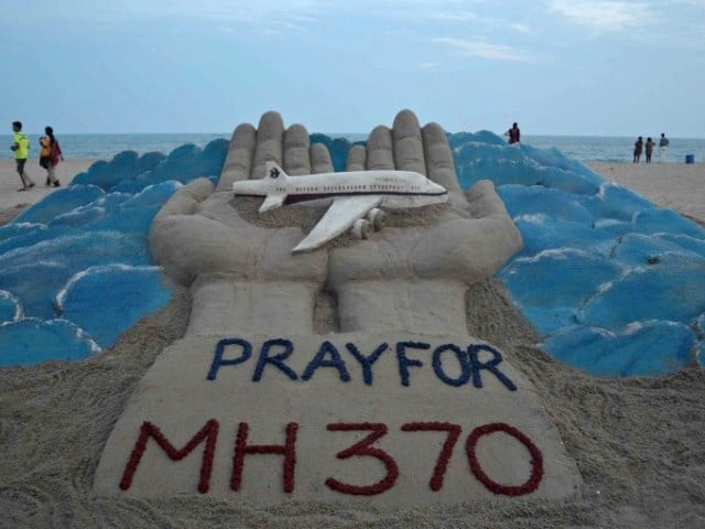 a sand sculpture made by indian sand artist sudersan pattnaik with a message of prayers for the missing malaysian airlines flight mh370 photo afp a sand sculpture made by indian sand artist sudersan pattnaik with a message of prayers for the missing malaysian airlines flight mh370 photo afp
