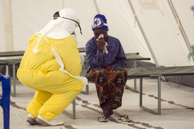 in a file photo a health worker wearing protective gear attends to a newly admitted suspected ebola patient in a quarantine zone at a red cross facility in the town of koidu kono district in eastern sierra leone december 19 2014 photo afp in a file photo a health worker wearing protective gear attends to a newly admitted suspected ebola patient in a quarantine zone at a red cross facility in the town of koidu kono district in eastern sierra leone december 19 2014 photo afp