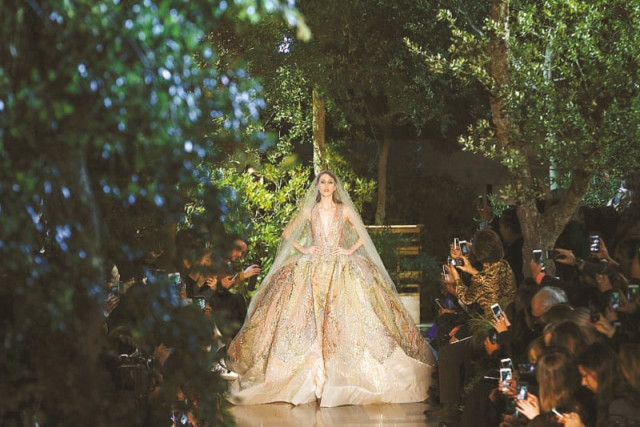 saab s showstopper was a wedding gown with the delicacy of butterfly wings encrusted with tiny sequins and pearls in pale pink green and silver photos afp reuters saab s showstopper was a wedding gown with the delicacy of butterfly wings encrusted with tiny sequins and pearls in pale pink green and silver photos afp reuters