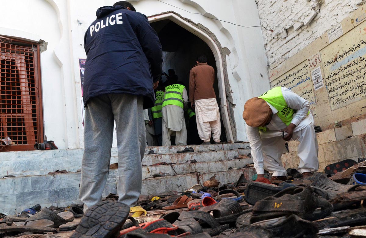 security and rescue officials examine the site of the blast photo afp