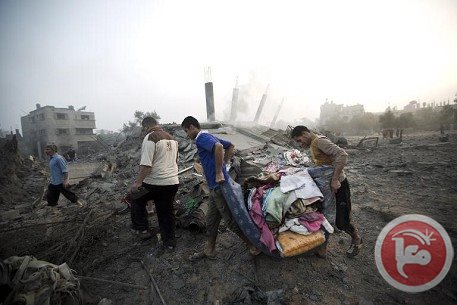 palestinians collect their belongings from damaged house after an israeli missile strike hit gaza city on july 8 2014 photo afp