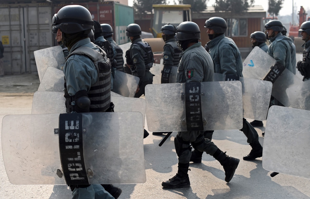 afghan riot police walk towards a protest against the printing of satirical sketches of the prophet muhammad by french magazine charlie hebdo along the kabul jalalabad road in kabul on january 31 2015 photo afp