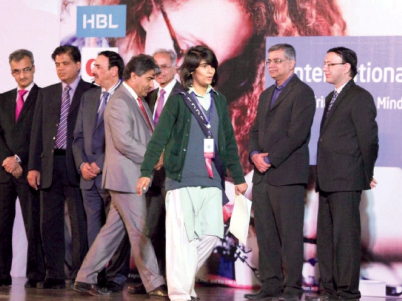 a young student walks off stage after collecting her certificate at the event photo muhammad javaid express