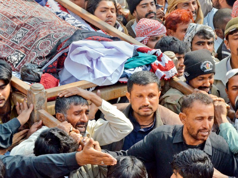 mourners carry the remains of a blast victim for burial in shikarpur photo afp