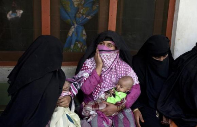 a woman holds a child while waiting their turn to receive fortified food supplements at a centre for malnourished women and children in baidara in swat valley photo reuters a woman holds a child while waiting their turn to receive fortified food supplements at a centre for malnourished women and children in baidara in swat valley photo reuters