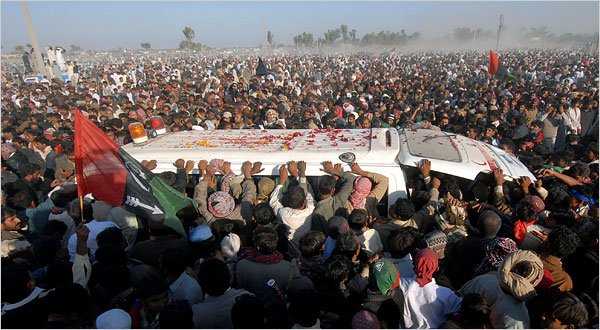 the ambulance carrying benazir bhutto s coffin crawled through mourners photo afp