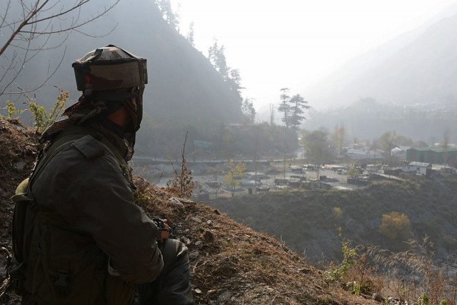 an indian soldier keeps watch from his position overlooking army barracks near the line of control loc photo afp an indian soldier keeps watch from his position overlooking army barracks near the line of control loc photo afp