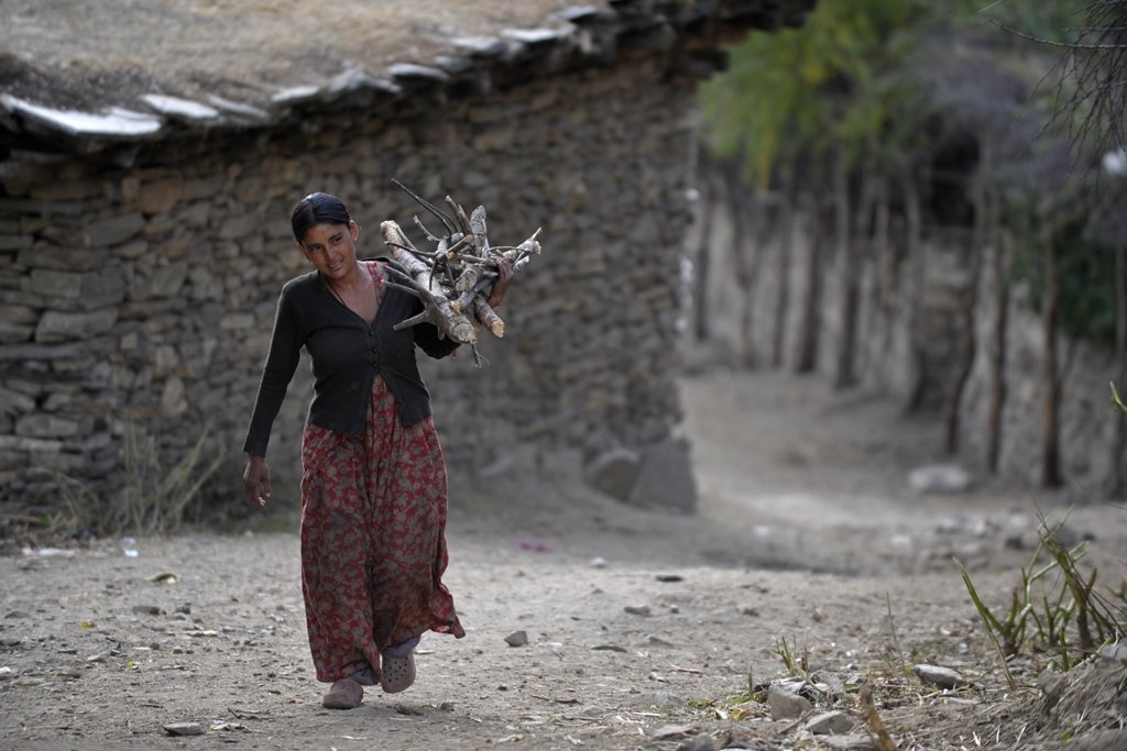 nepalese resident dana sunar c 18 who is the last member of the dalit caste in her class carries firewood in simikot the headquarters of humla district some 430 kms north west of kathmandu photo afp