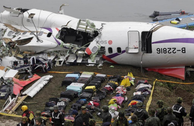 baggages are placed near the wreckage of transasia airways plane flight ge235 after it crash landed into a river in new taipei city taiwan photo reuters baggages are placed near the wreckage of transasia airways plane flight ge235 after it crash landed into a river in new taipei city taiwan photo reuters