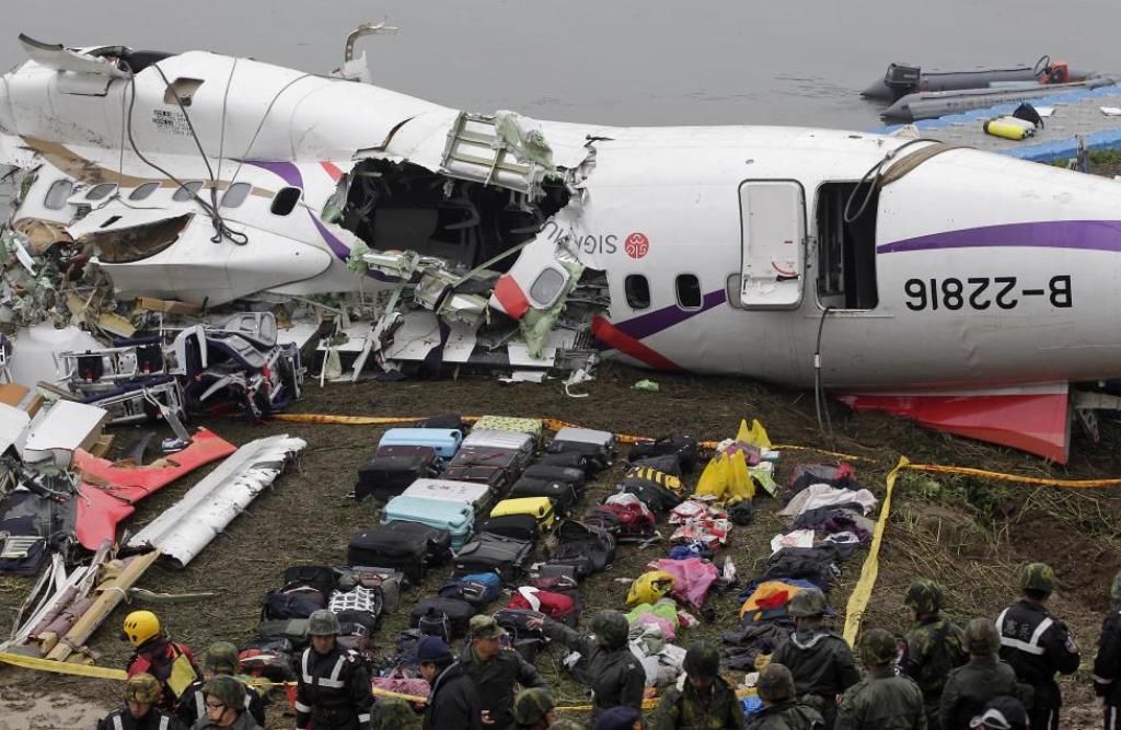 baggages are placed near the wreckage of transasia airways plane flight ge235 after it crash landed into a river in new taipei city taiwan photo reuters