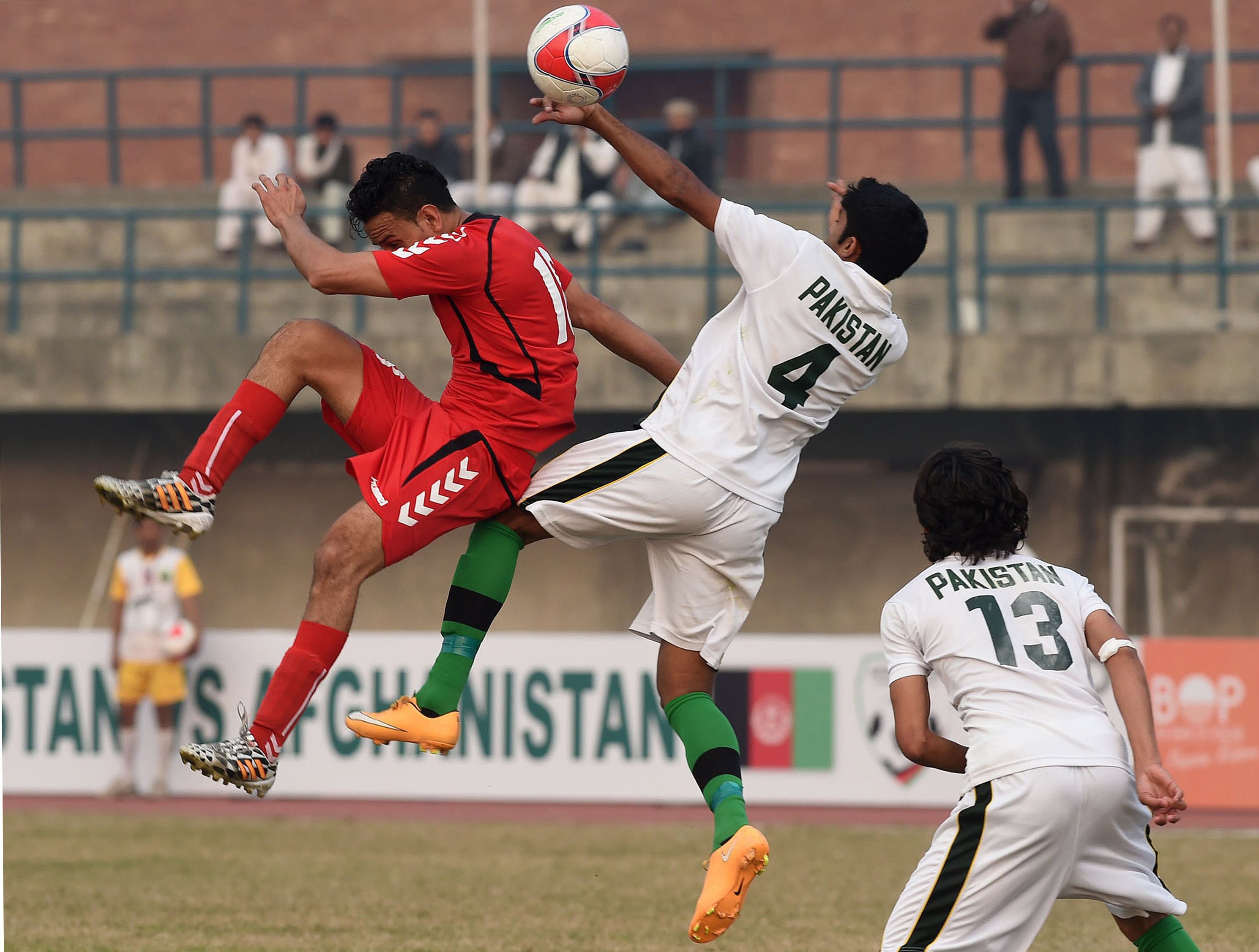 afghan 039 s ahmad arash l vies for the ball with pakistan 039 s mohammad bilal during their friendly football match at the punjab stadium in lahore on february 6 2015 photo afp