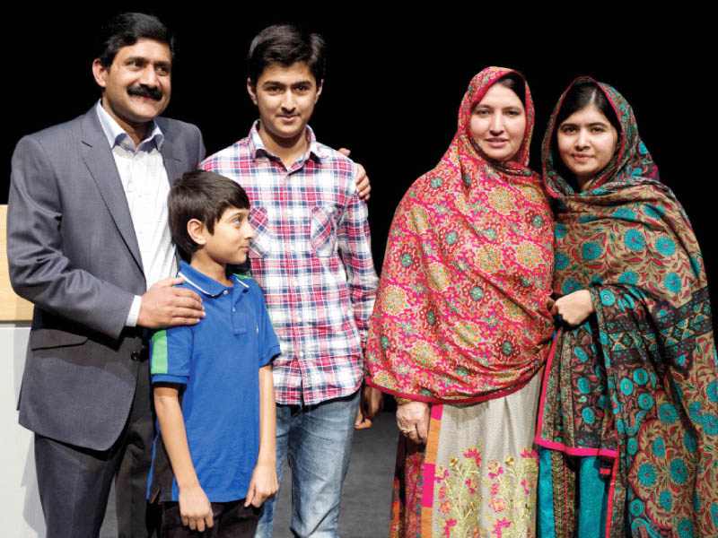 malala poses for a photograph with her family after addressing the media in birmingham england photo afp