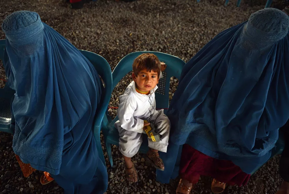 an afghan refugee family sitting at the united nations high commissioner for refugees unhcr registration centre on the outskirts of peshawar before their departure to their home country photo afp an afghan refugee family sitting at the united nations high commissioner for refugees unhcr registration centre on the outskirts of peshawar before their departure to their home country photo afp