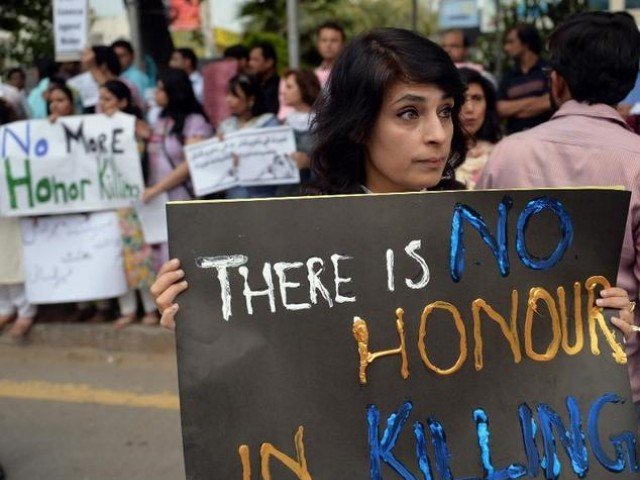 a human rights activists hold placards during a protest in islamabad against the killing of pregnant woman farzana parveen in lahore on may 29 2014 photo afp