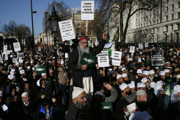 muslim demonstrators hold placards during a protest against the publication of cartoons depicting the prophet mohammad in french satirical weekly charlie hebdo near downing street in central london february 8 2015 at least 1 000 british muslims protested in central london on sunday against what they called quot insulting depictions quot of the prophet mohammad by french newspaper charlie hebdo the event comes weeks after 17 people were killed in three days of violence last month in france that began when two islamist gunmen burst into charlie hebdo 039 s paris offices opening fire in revenge for its publication of satirical images of mohammad sunday 039 s protest organisers condemned the paris attacks but said the magazine should not publish cartoons of the prophet photo reuters