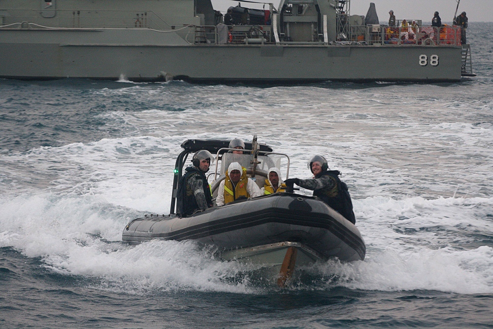 in this file photo australian navy personnel transfer afghanistan asylum seekers to a indonesian rescue boat near panaitan island west java on august 31 2012 after the refugee 039 s boat sunk photo afp