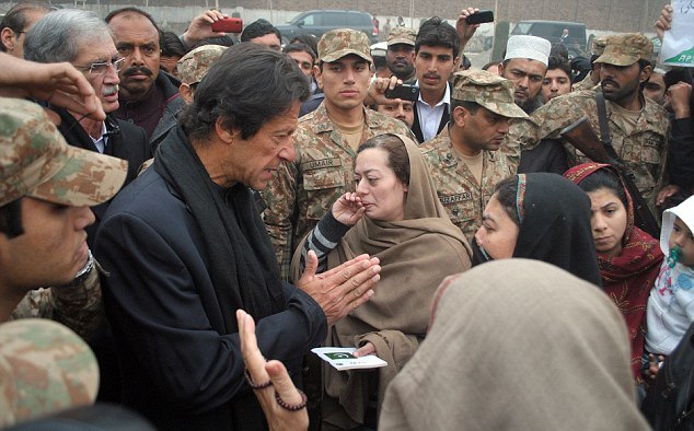 a file photo of pti chief imran khan meeting parents of the aps victims photo afp