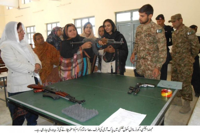 an army lieutenant showing a teacher how to handle firearms photo hairan momand express tribune an army lieutenant showing a teacher how to handle firearms photo hairan momand express tribune