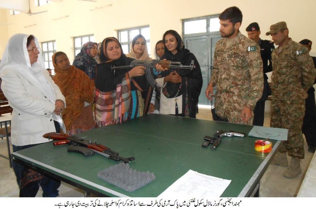 an army lieutenant showing a teacher how to handle firearms photo hairan momand express tribune