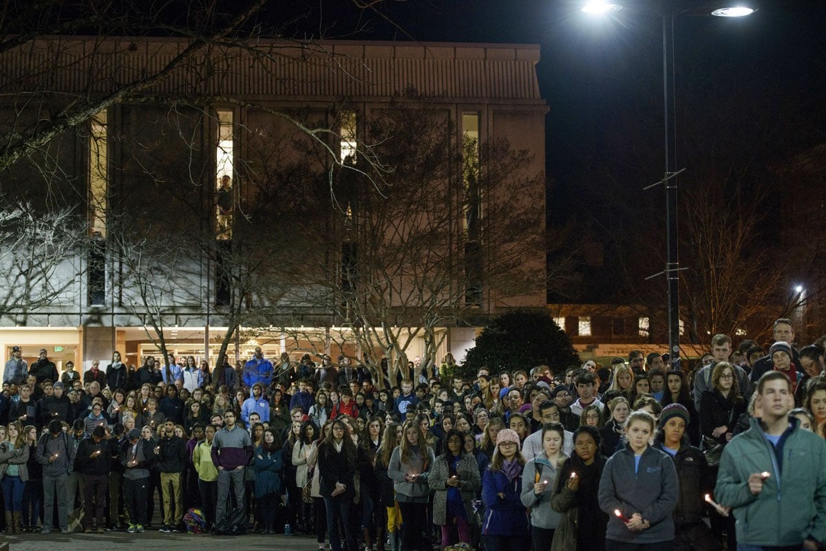 people listen during a vigil at the university of north carolina following the murders of three muslim students on february 11 2015 in chapel hill north carolina photo afp