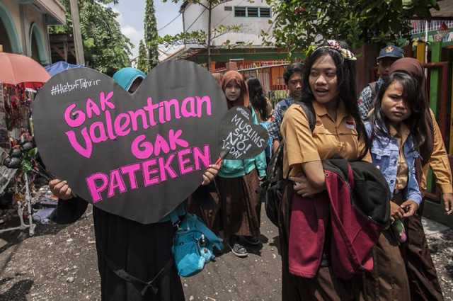 a member of indonesia 039 s conservative islamic organization hizbut tahrir holds a placard during an anti valentine 039 s day protest outside a school in surabaya city eastern java island on february 13 2015 muslim clerics across indonesia have warned against celebrating valentine 039 s day which they regard as western celebration that promotes sex drinking alcohol and drug use photo afp a member of indonesia 039 s conservative islamic organization hizbut tahrir holds a placard during an anti valentine 039 s day protest outside a school in surabaya city eastern java island on february 13 2015 muslim clerics across indonesia have warned against celebrating valentine 039 s day which they regard as western celebration that promotes sex drinking alcohol and drug use photo afp