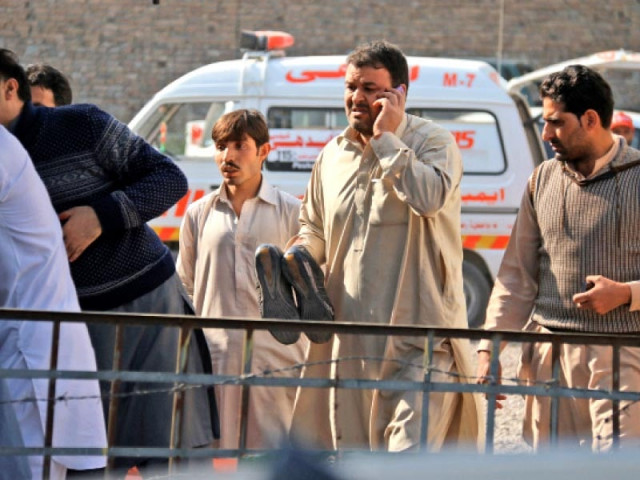 a man holds the shoes of his injured relative at the site of the blast photo muhammad iqbal express a man holds the shoes of his injured relative at the site of the blast photo muhammad iqbal express