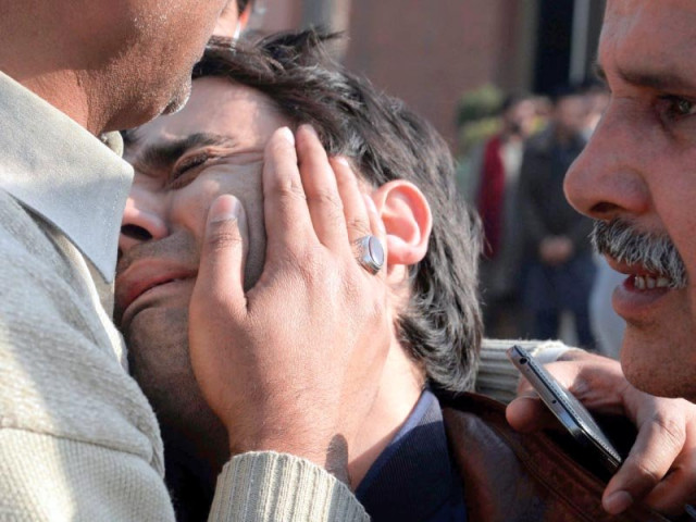 relatives comfort a distraught resident following an attack on a mosque in peshawar photo afp relatives comfort a distraught resident following an attack on a mosque in peshawar photo afp