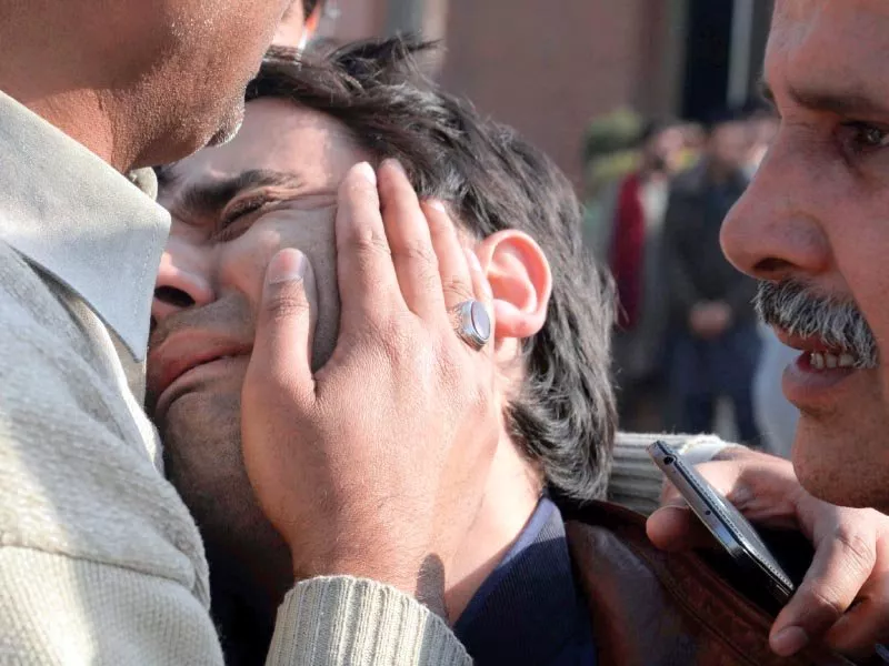 relatives comfort a distraught resident following an attack on a mosque in peshawar photo afp relatives comfort a distraught resident following an attack on a mosque in peshawar photo afp