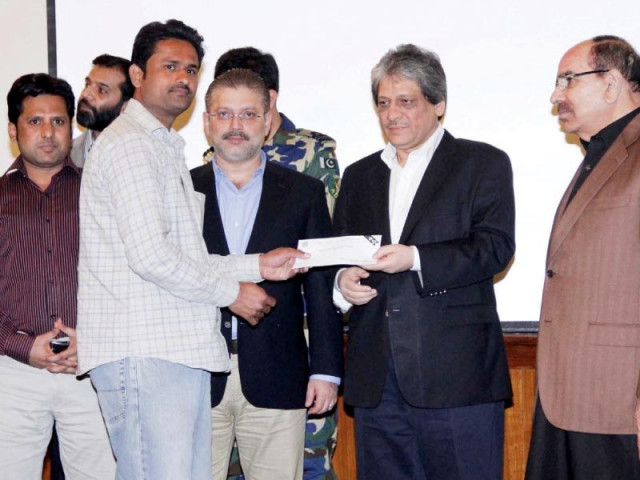 bahria town chief malik riaz looks on as sindh governor dr ishratul ibad distributes cheques among the traders of karachi s timber market affected by a devastating blaze photo inp bahria town chief malik riaz looks on as sindh governor dr ishratul ibad distributes cheques among the traders of karachi s timber market affected by a devastating blaze photo inp