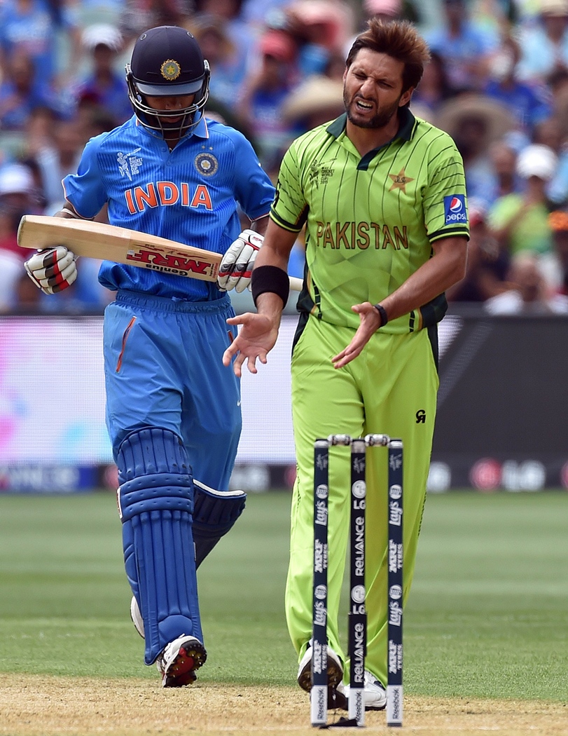 pakistan 039 s spin bowler shahid afridi r gestures as india 039 s batsman shikhar dhawan l gains his ground during the pool b 2015 cricket world cup match between indian and pakistan at the adelaide oval on february 15 2015 photo afp