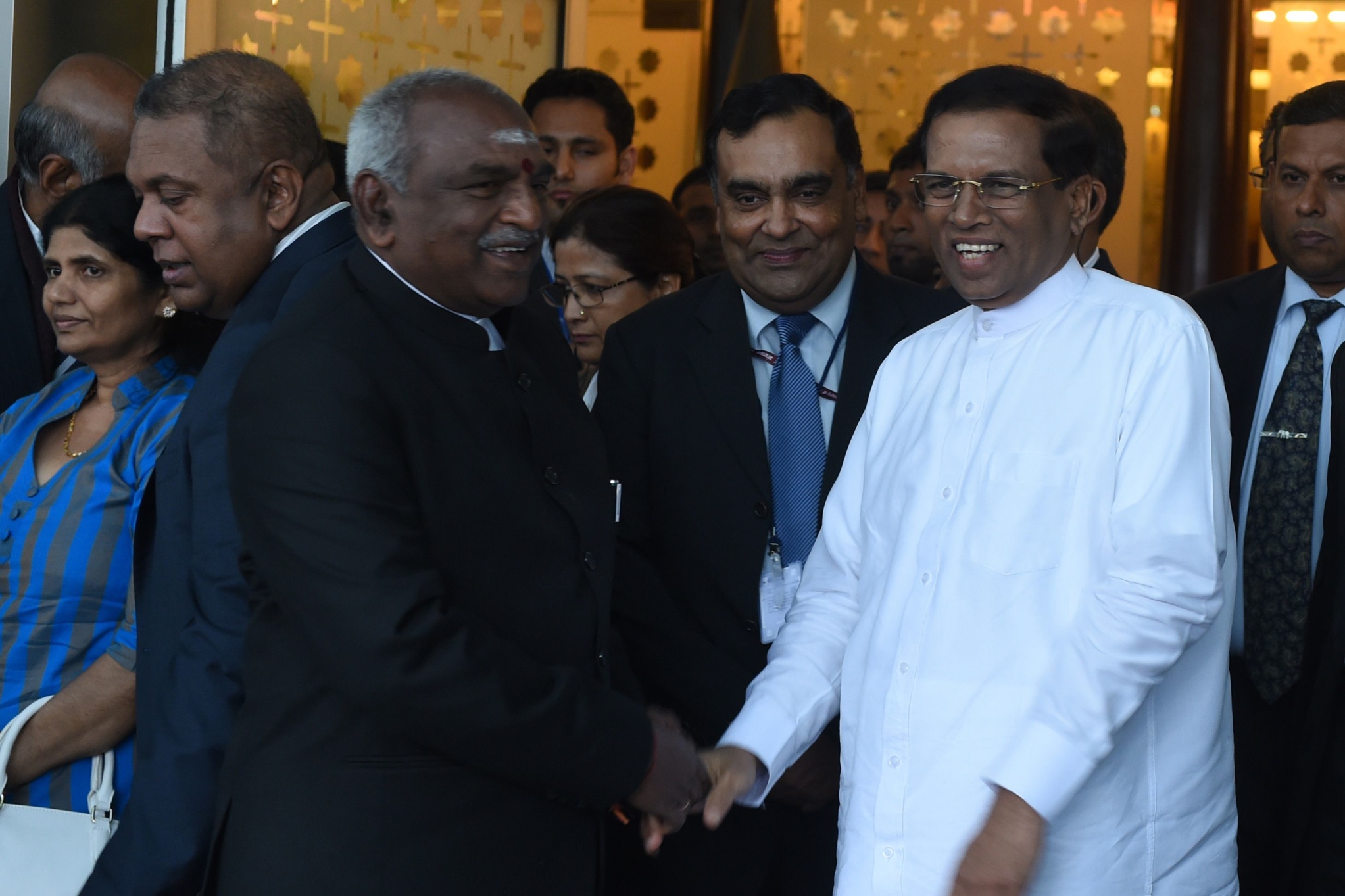 sri lankan president maithripala sirisena r is welcomed by indian minister of state for shipping p radhakrishnan at the indra gandhi international airport in new delhi on february 15 2015 photo afp