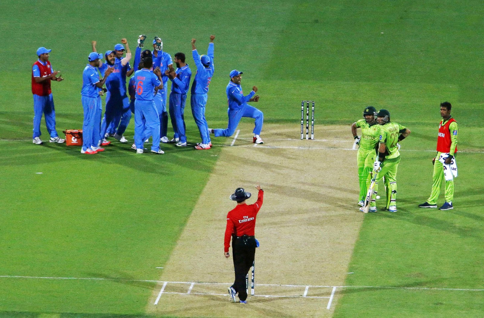 members of india 039 s cricket team celebrate after an electronic review confirmed the dismissal of pakistan 039 s batsman umar akmal 3rd r caught by wicket keeper mahendra dhoni during their cricket world cup match in adelaide february 15 2015 photol reuters