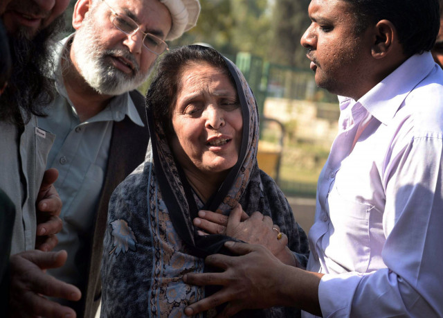 in this file photo relatives comfort a woman following the mosque attack in peshawar on february 13 2015 photo afp in this file photo relatives comfort a woman following the mosque attack in peshawar on february 13 2015 photo afp