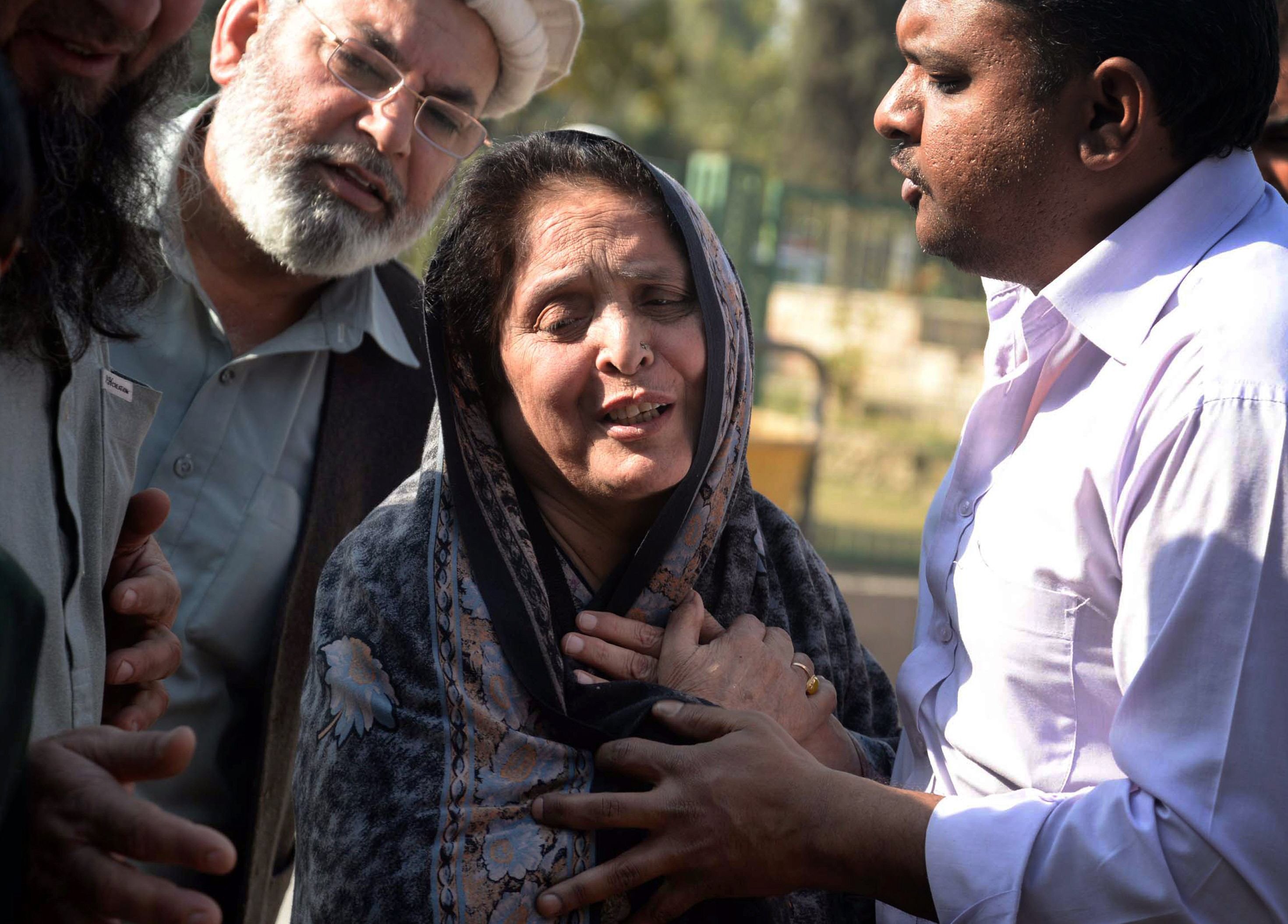 in this file photo relatives comfort a woman following the mosque attack in peshawar on february 13 2015 photo afp