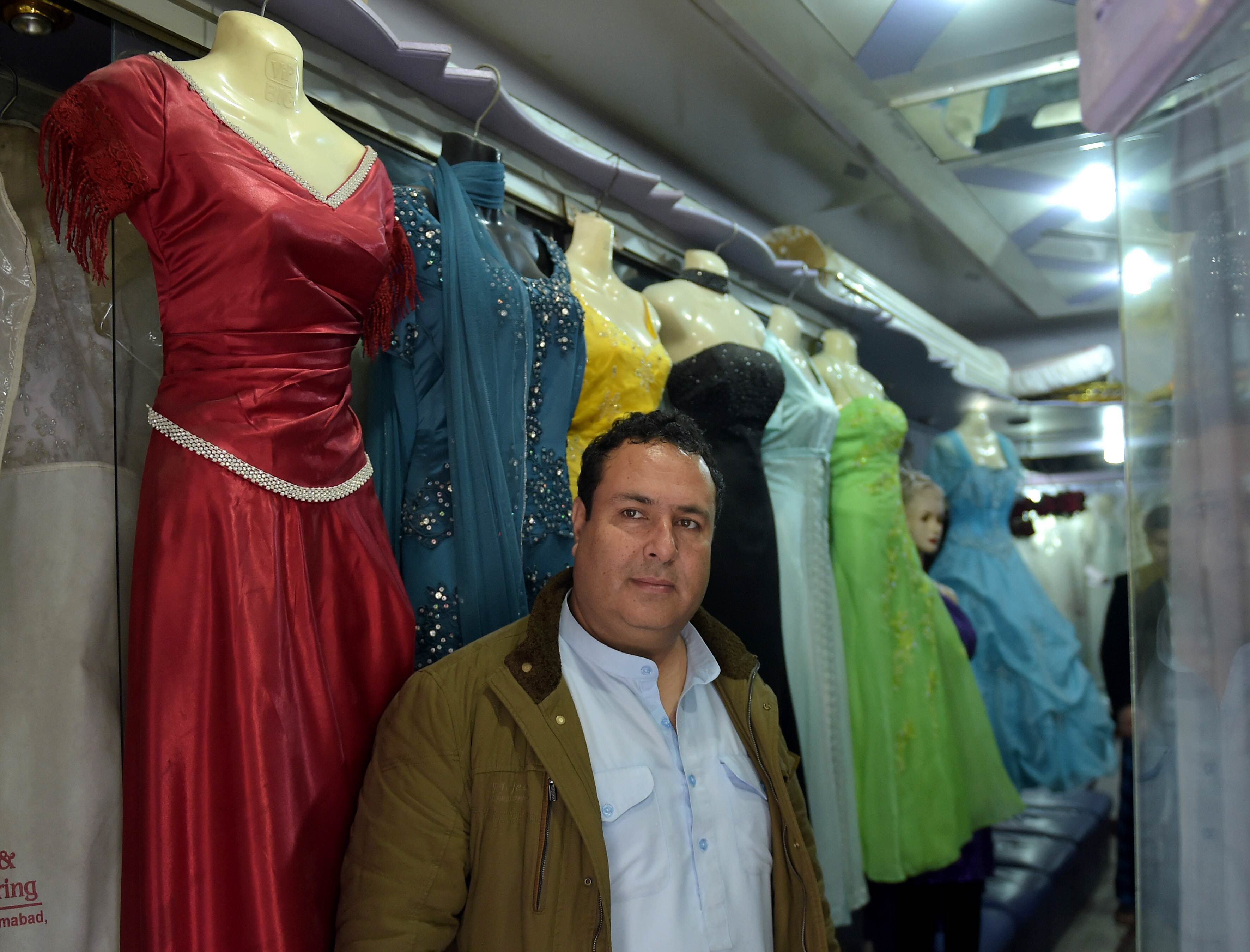 in this photograph taken on february 2 2015 afghan national of tajik origin raza sakhi poses in his bridal dress shop in islamabad photo afp