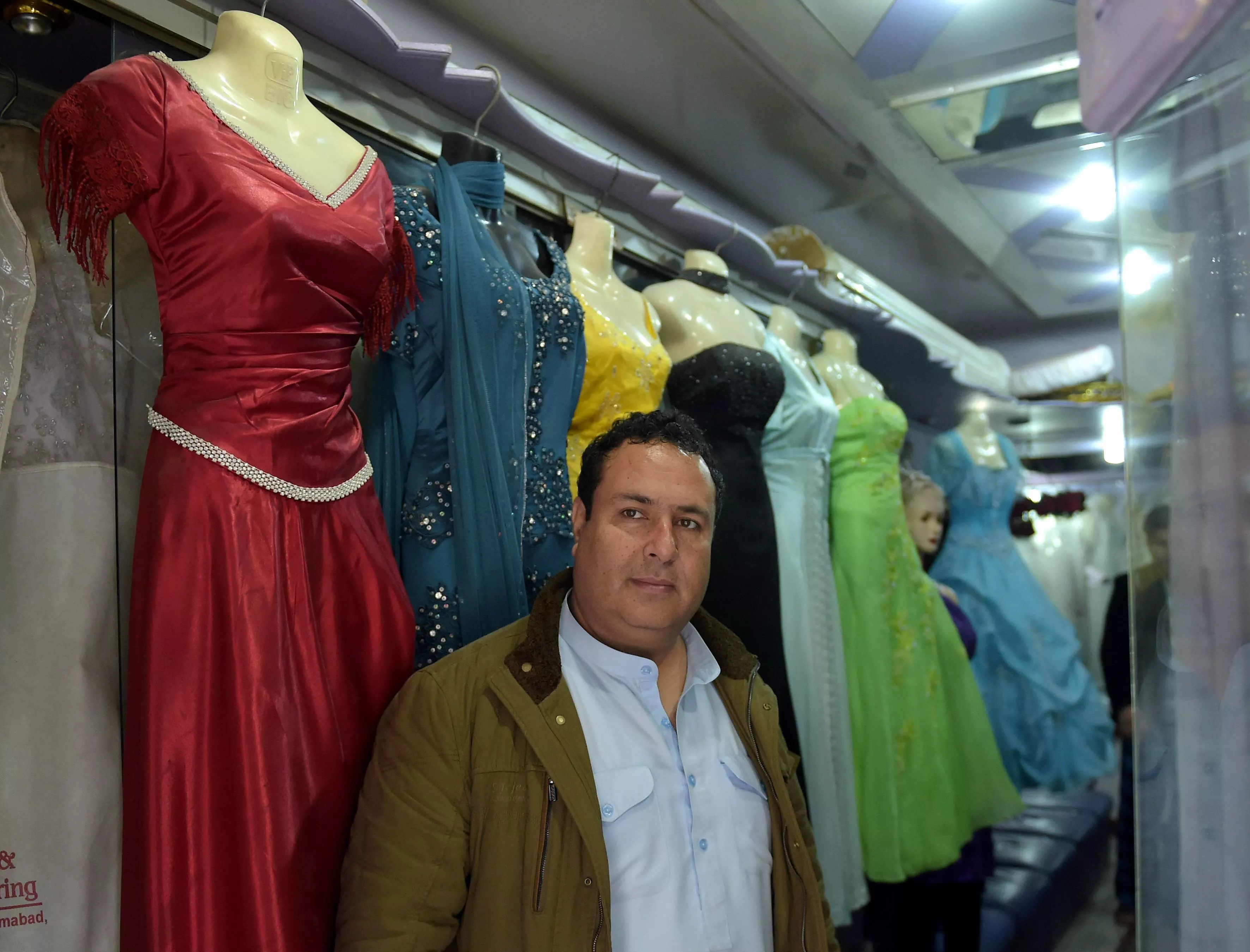in this photograph taken on february 2 2015 afghan national of tajik origin raza sakhi poses in his bridal dress shop in islamabad photo afp in this photograph taken on february 2 2015 afghan national of tajik origin raza sakhi poses in his bridal dress shop in islamabad photo afp
