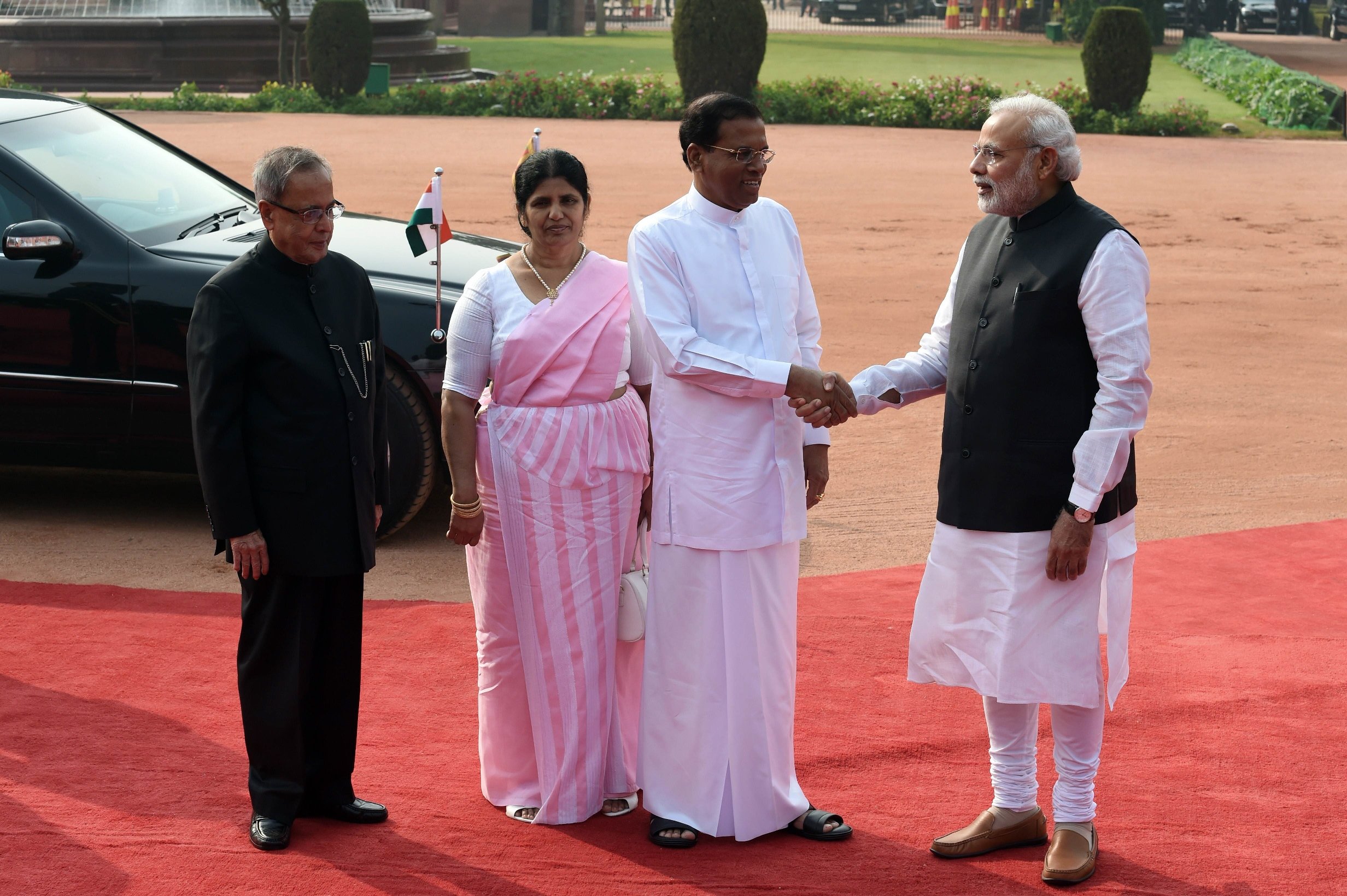 sri lankan president maithripala sirisena shakes hands with indian prime minister narendra modi as indian president pranab mukherjee and the first lady of sri lanka jayanthi pushpakumari look on during the welcome ceremony for the sri lankan dignatary at the presidential palace in new delhi on february 16 2015 photo afp