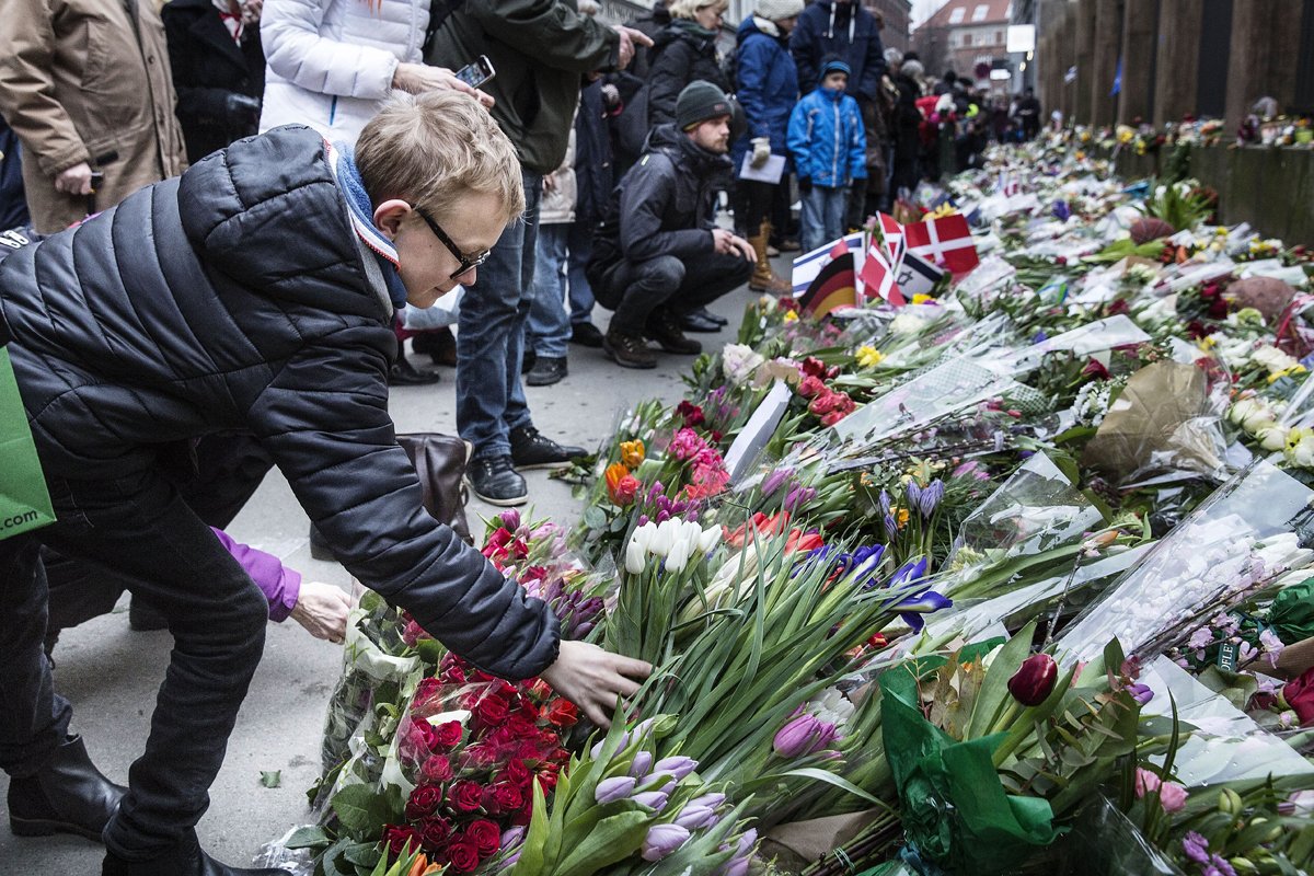 people put flowers to honour the shooting victims outside the main synagogue of copenhagen on february 16 2015 after last week end two fatal attacks photo afp