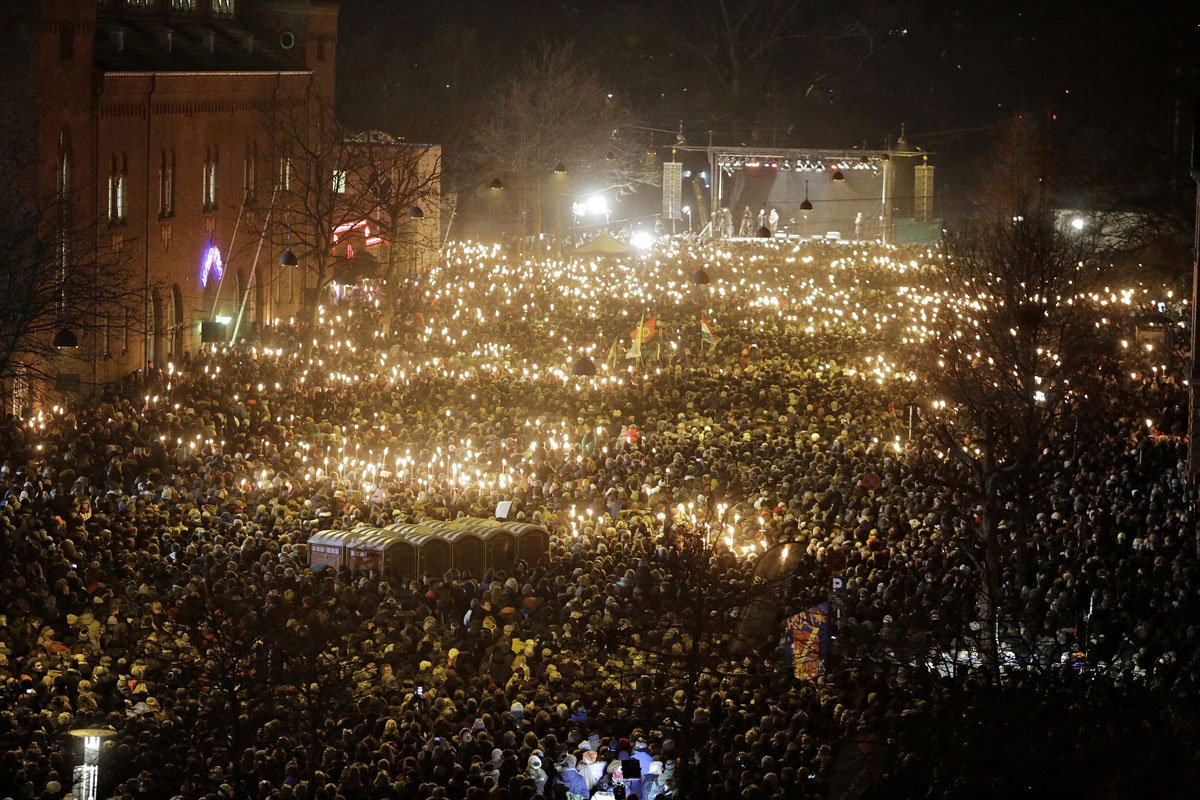 people hold candles during a memorial service for those killed by a gunman at the weekend in copenhagen on february 16 2015 the attacks which targeted a debate on islam and free speech and a synagogue came just a month after the islamist attacks in paris at satirical newspaper charlie hebdo office and a kosher supermarket photo afp