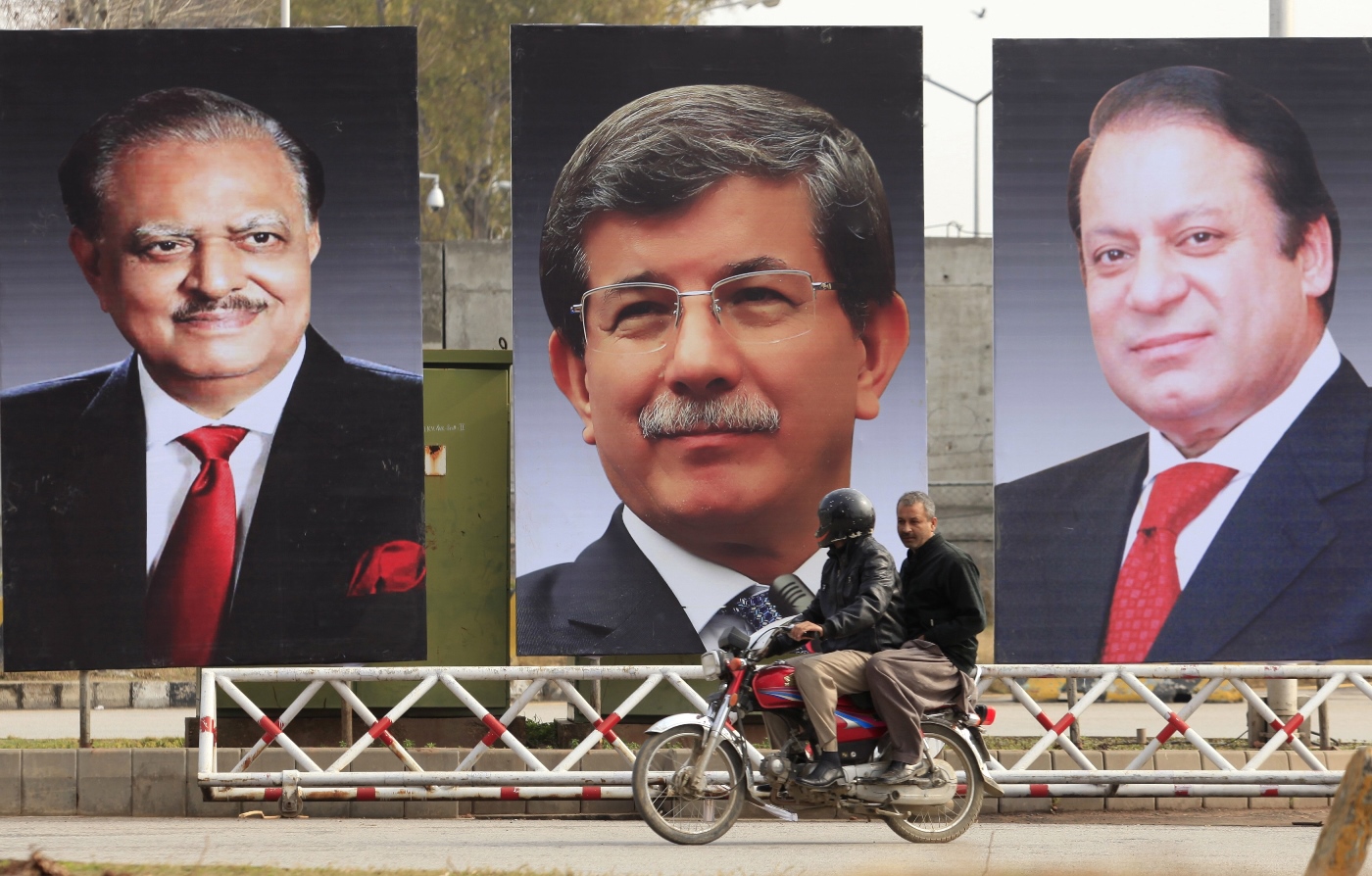 men ride a motorcycle past giant portraits of pakistan 039 s president mamnoon hussain turkish prime minister ahmet davutoglu and pakistan 039 s prime minister nawaz sharif displayed along a road in islamabad february 17 2015 photo reuters