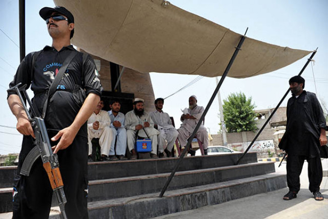 in this file photo a police commando guards a polio vaccination team photo afp in this file photo a police commando guards a polio vaccination team photo afp