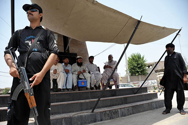 in this file photo a police commando guards a polio vaccination team photo afp