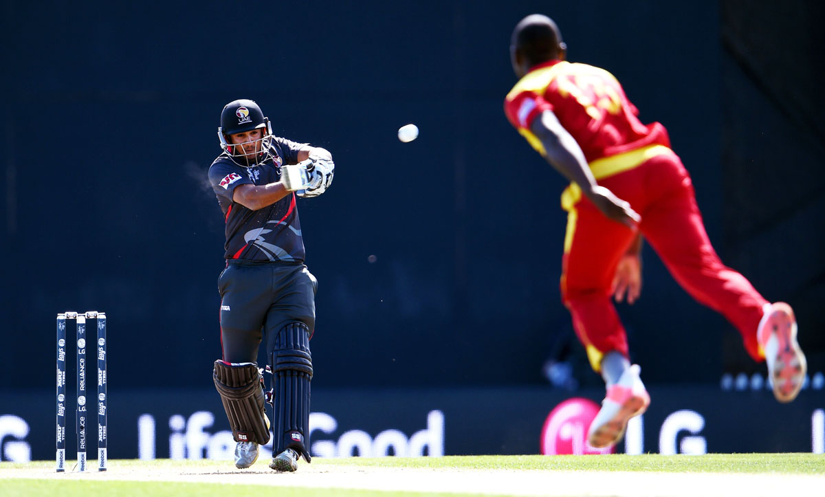 united arab emirates batsman andri berenger l pulls a ball to the boundary from zimbabwe fast bowler tendai chatara r during their 2015 cricket world cup match in nelson on february 19 2015 photo afp