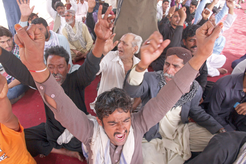 the families of the shikarpur blast victims raise their hands in celebration as the sindh government accepted most of their demands the families had marched from shikarpur on sunday and were protesting at numaish chowrangi since tuesday night photo athar khan express