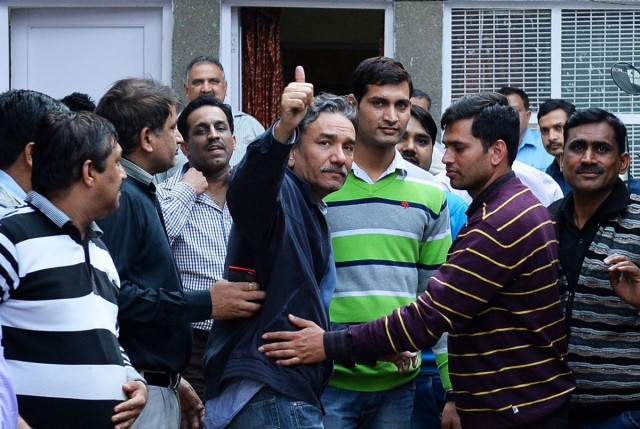 indian journalist santanu saikia c gestures as he is escorted back to a cell ahead of a court appearance in new delhi on february 20 2014 photo afp indian journalist santanu saikia c gestures as he is escorted back to a cell ahead of a court appearance in new delhi on february 20 2014 photo afp